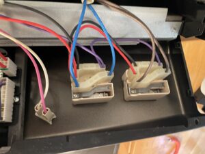 Inside Amana stove control panel, showing two burner switches
