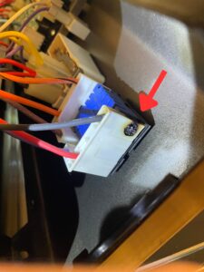 Stove affected infinite switch with clearly visible burnt mark