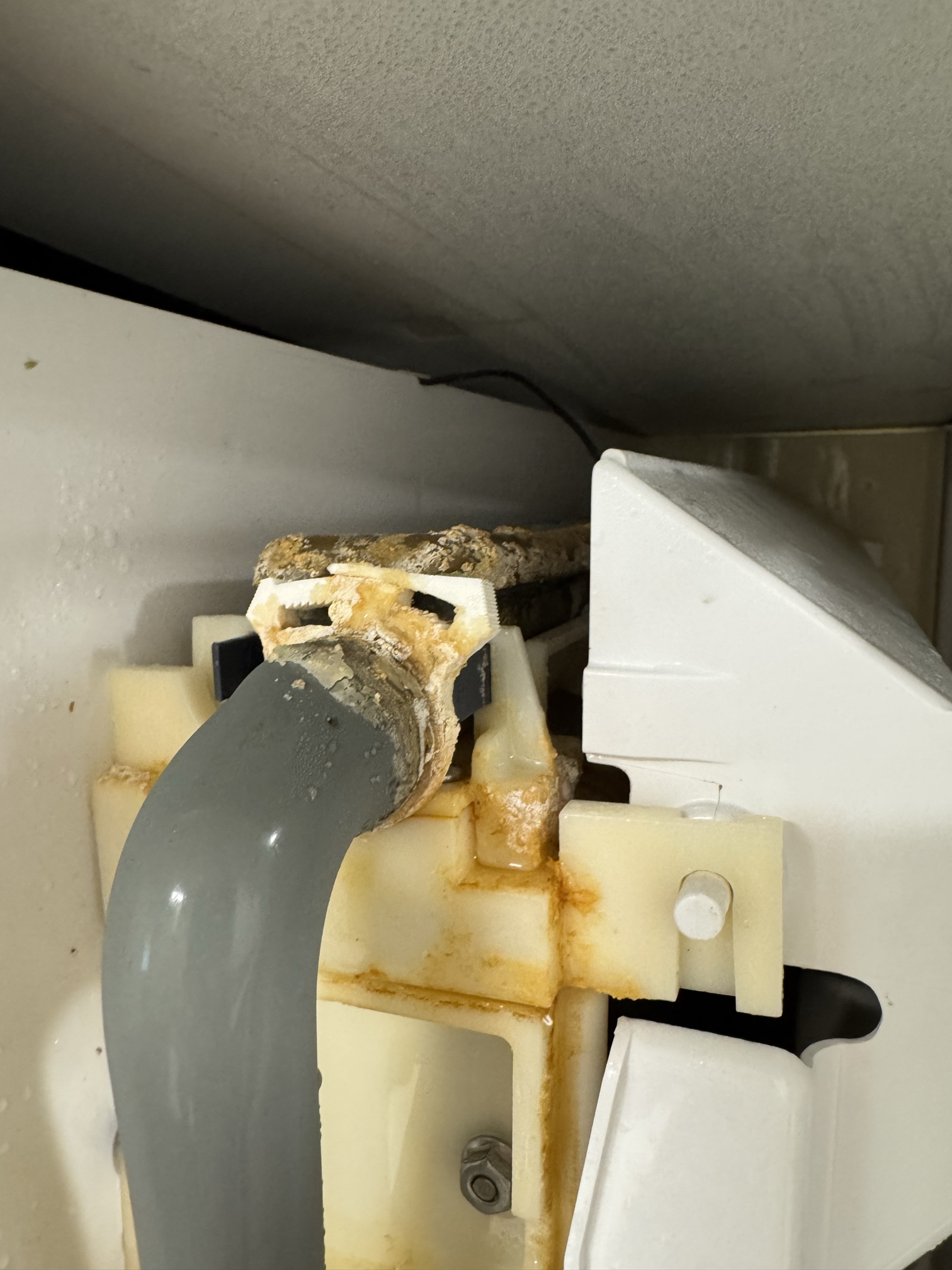 Heavy scale and mineral crust on the water inlet hose and fitting inside a neglected Scotsman ice machine
