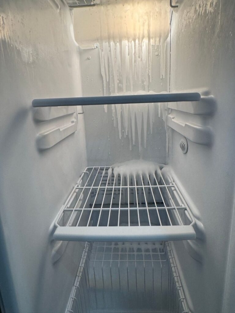 Ice running down the back wall of a side-by-side freezer