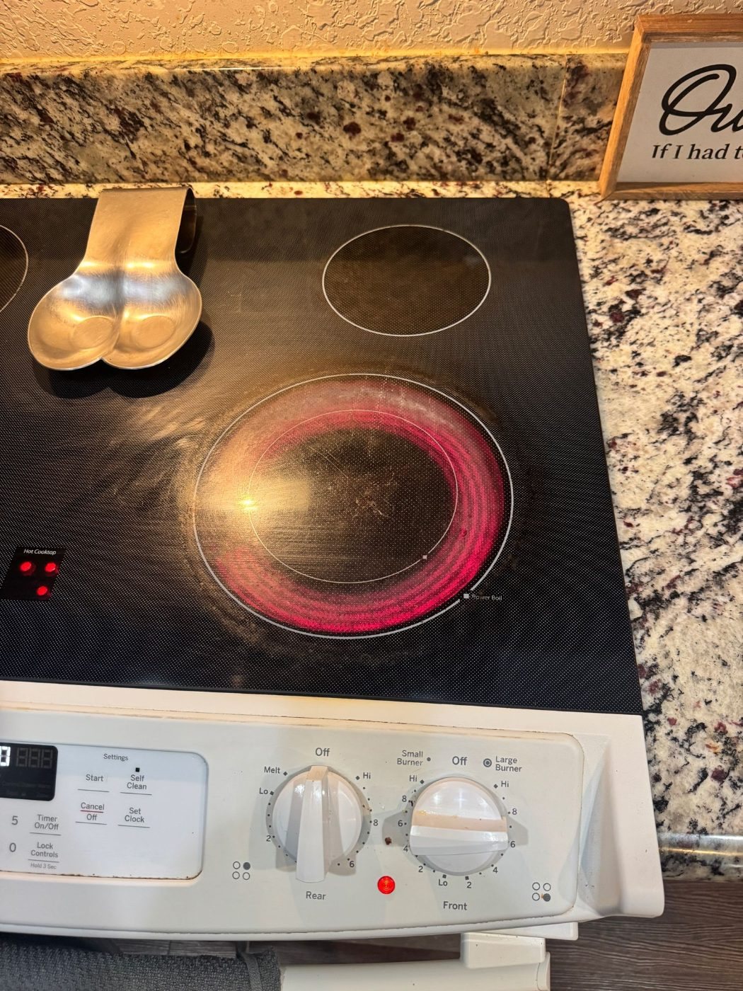 GE glass top range burner glowing red on high