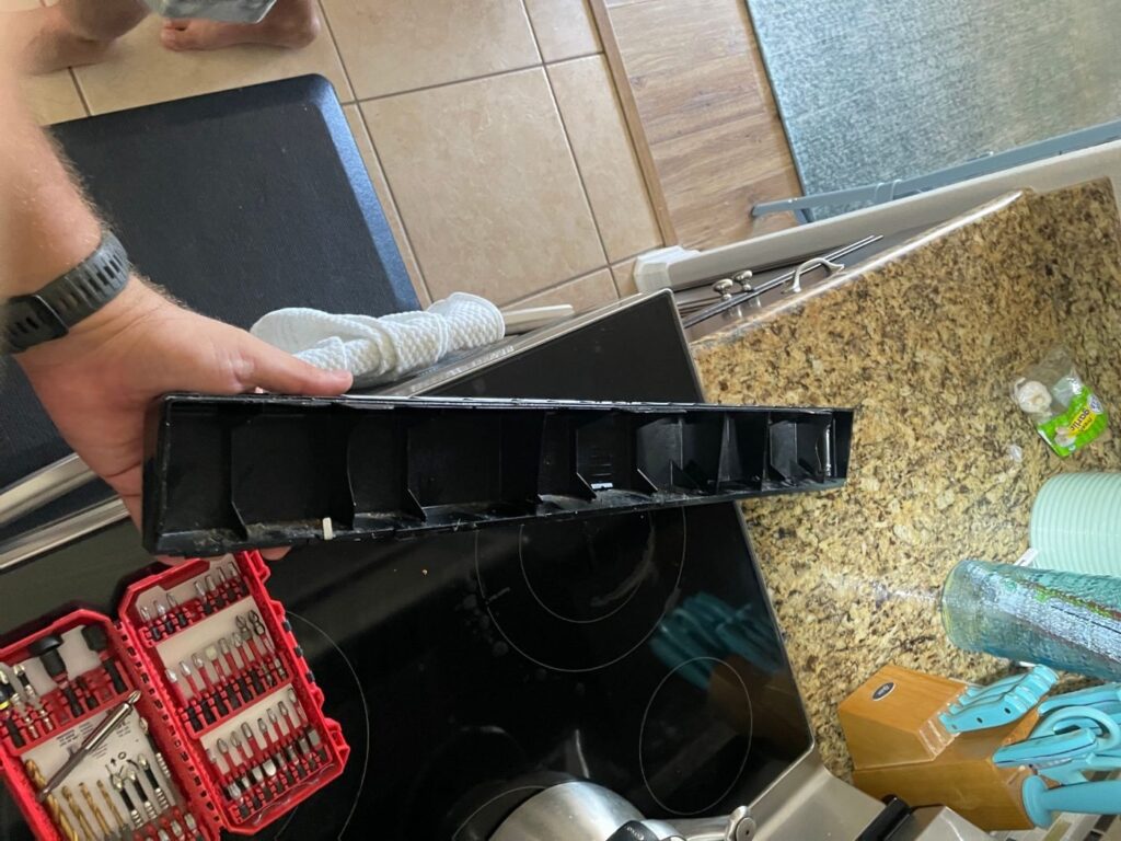 Brittle upper trim panel removed from a GE microwave