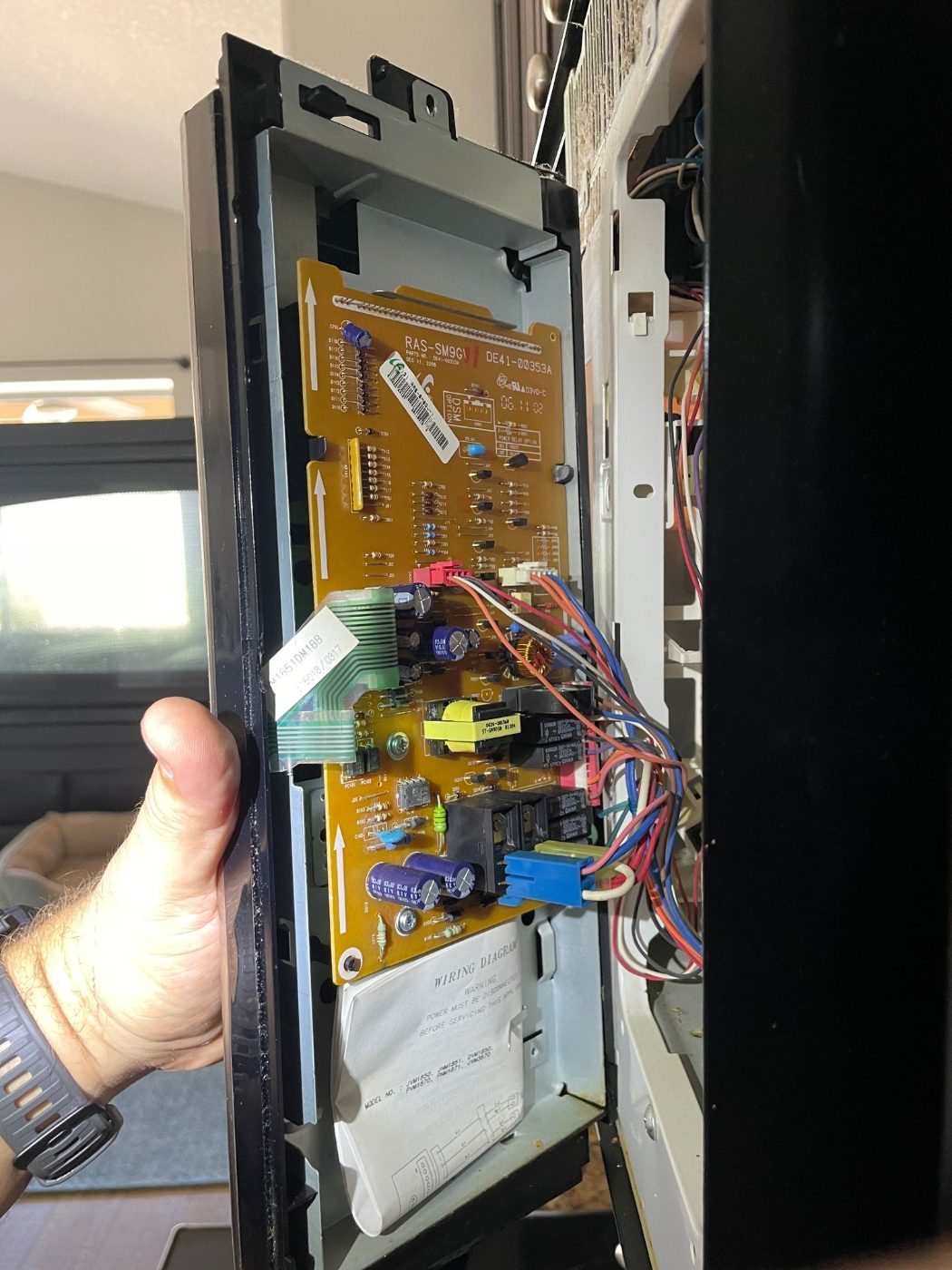 Control board on the door frame of a GE over-the-range microwave