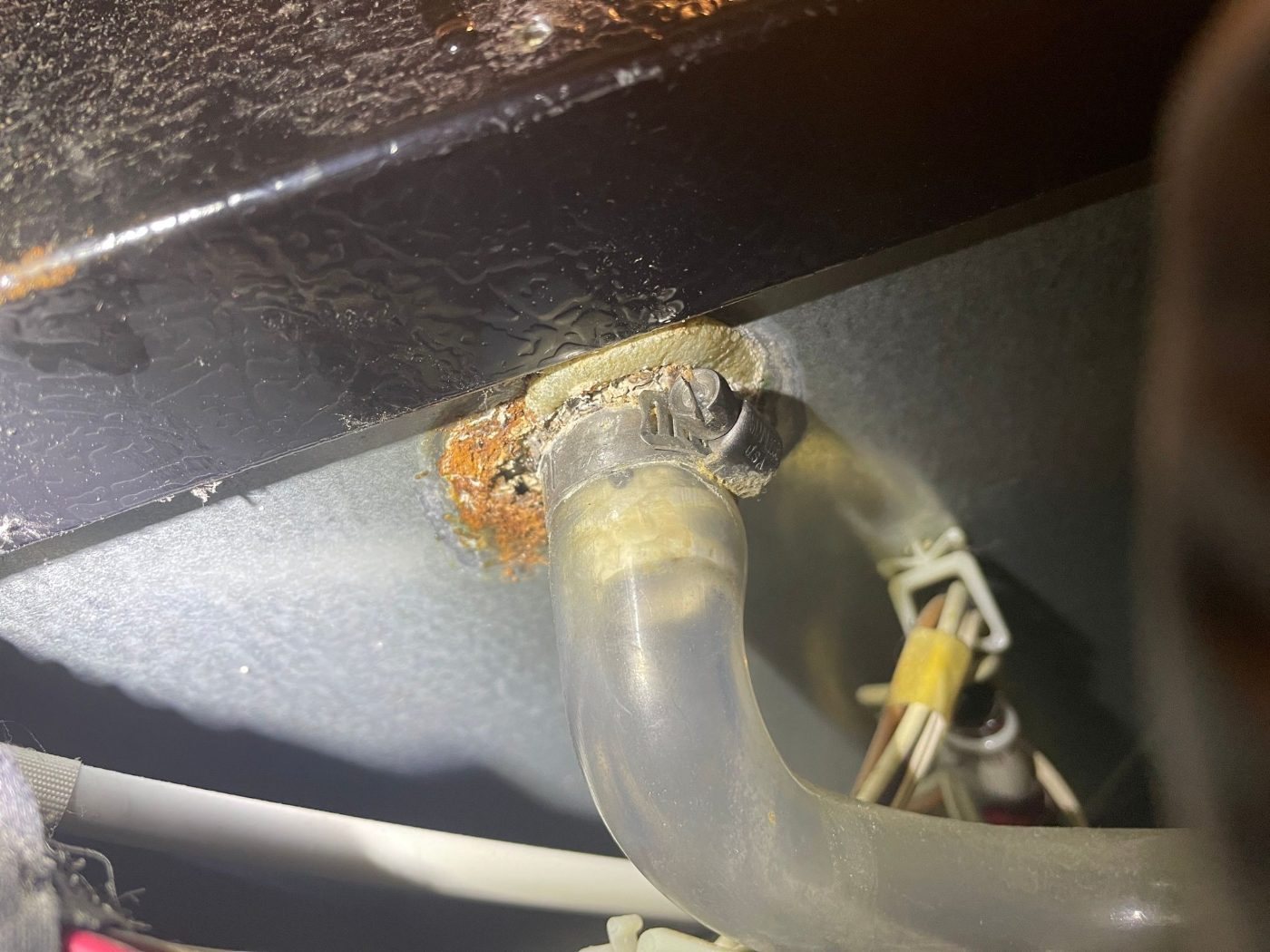 Corrosion at a leaking water pump outlet on a JennAir ice machine