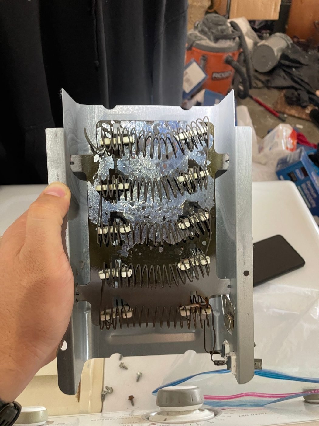 Failed heating element removed from a Maytag electric dryer