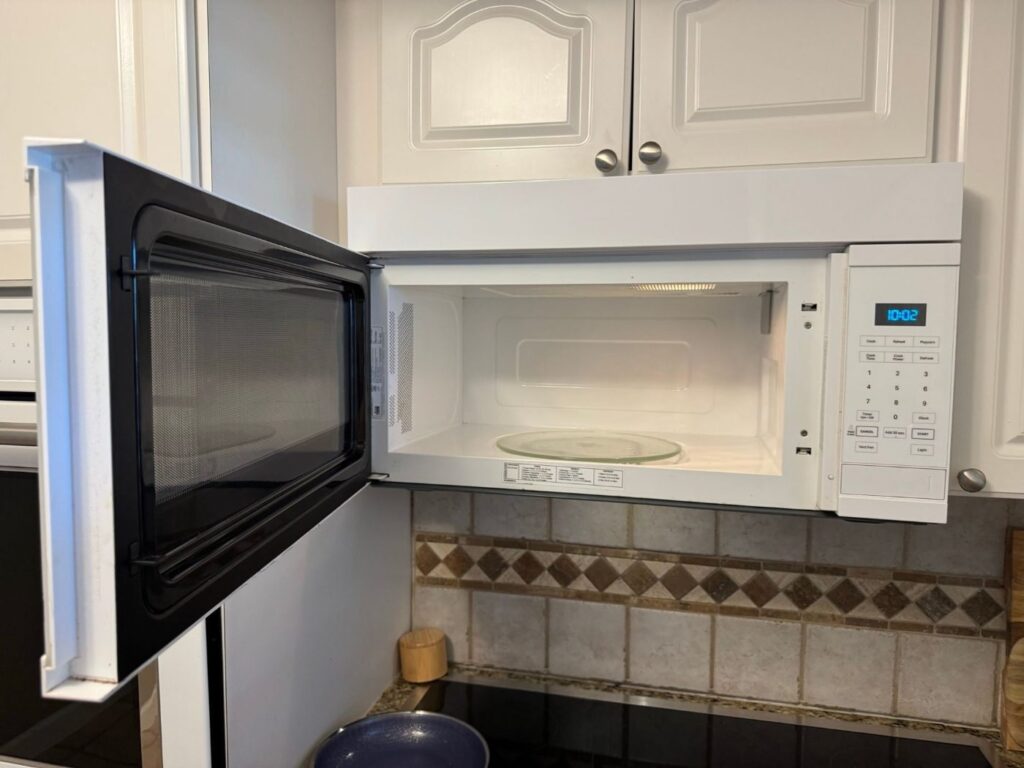 Over-the-range microwave with the door open before magnetron replacement