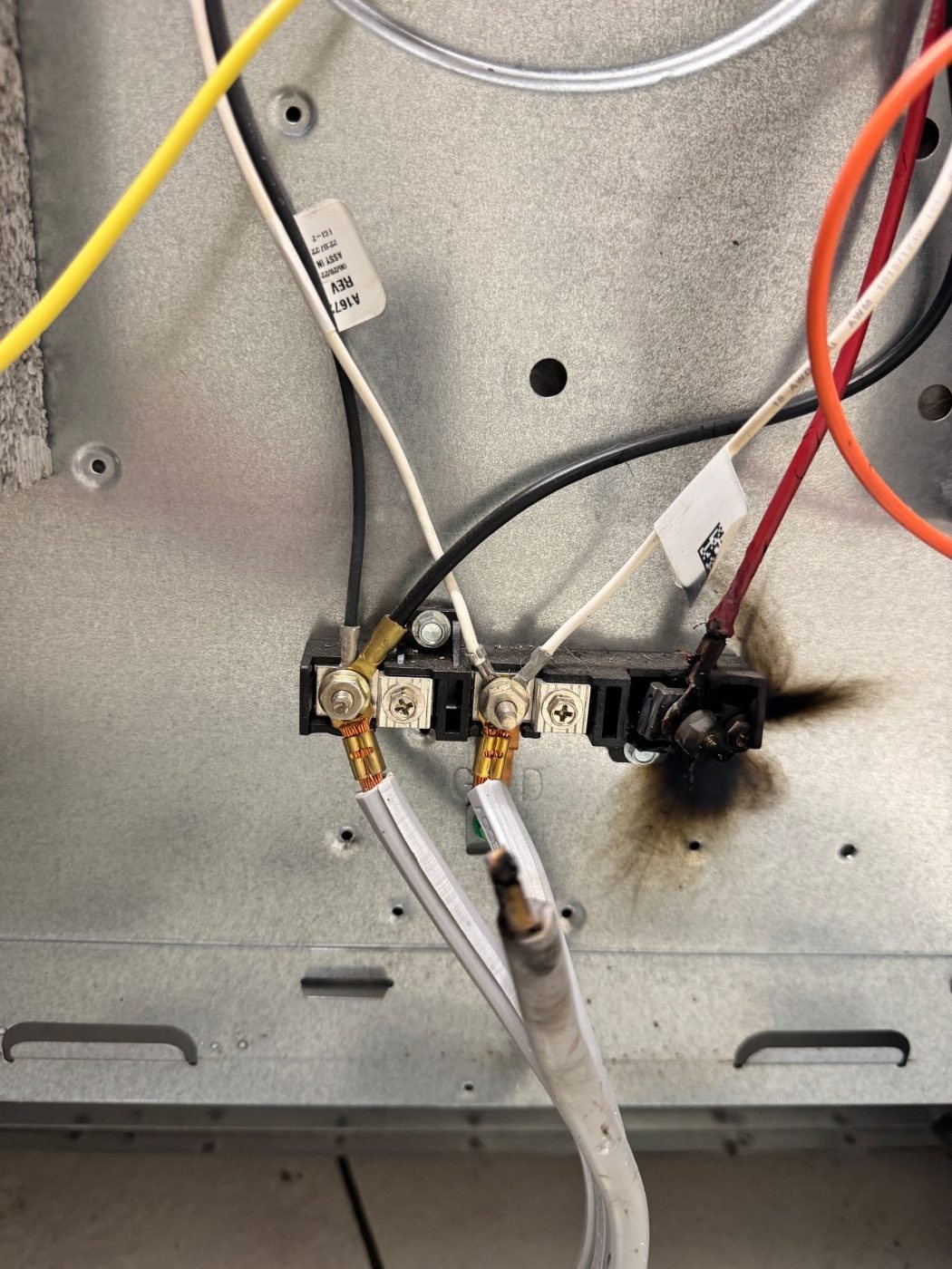Burnt terminal block and power cord on an electric range