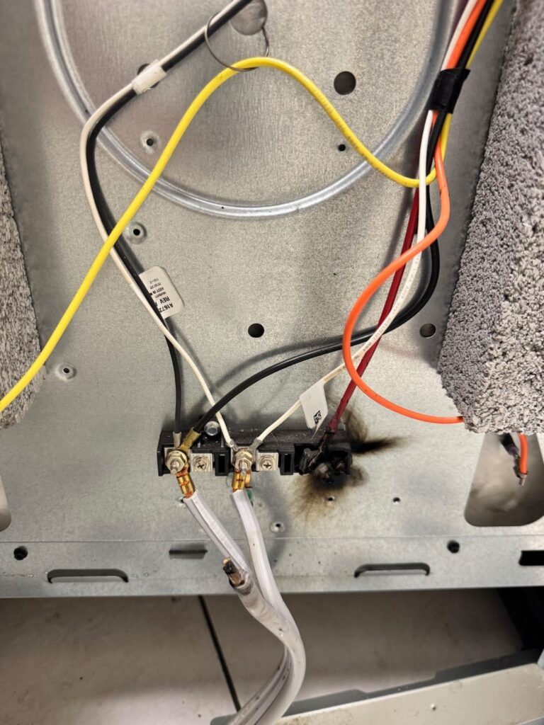 Arcing damage at the power cord connection of an electric range